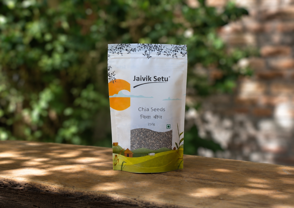 A stand-up pouch of Jaivik Setu Chia Seeds placed on a wooden surface with a blurred outdoor background of green foliage and a brick wall.